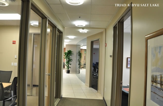 Triad 4 / BYU Salt Lake office corridor — drywall, ceiling grid, and glass partitions