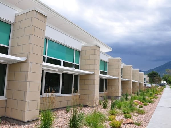 Commercial building row with Utah mountains — drywall and framing by Muddy Boys